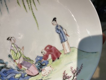 A Chinese famille rose cup and saucer with ladies and a boy playing with a rabbit, Yongzheng