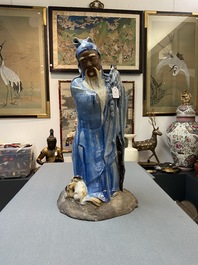 A large Chinese blue-glazed Shiwan pottery 'immortal' figure, 19th C.