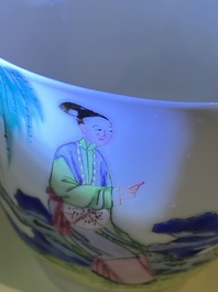 A Chinese famille rose cup and saucer with ladies and a boy playing with a rabbit, Yongzheng