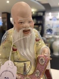 Two Chinese Yixing stoneware teapots and a famille rose 'Shou Lao' group, Kangxi and 20th C.