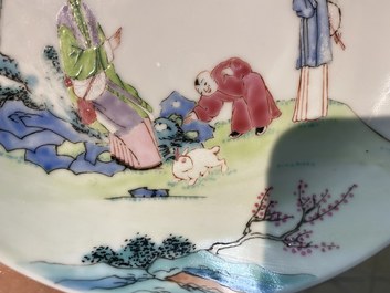 A Chinese famille rose cup and saucer with ladies and a boy playing with a rabbit, Yongzheng