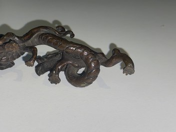 A rare Chinese bronze 'dragon' brush rest, Yuan/Ming