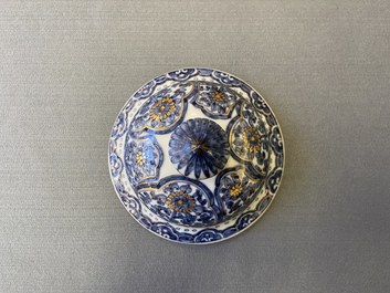 A Chinese gilt-heightened blue and white vase and cover, Kangxi/Yongzheng