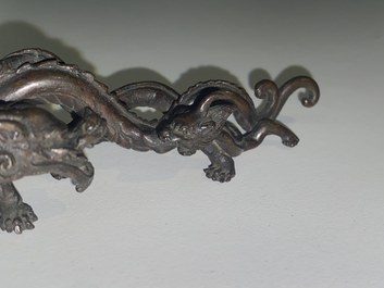 A rare Chinese bronze 'dragon' brush rest, Yuan/Ming