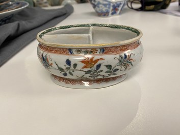 A Chinese doucai bowl, a famille verte spice box and a wucai tea caddy, Kangxi and later