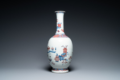 A Chinese blue, white and copper red 'antiquities' bottle vase, Qianlong