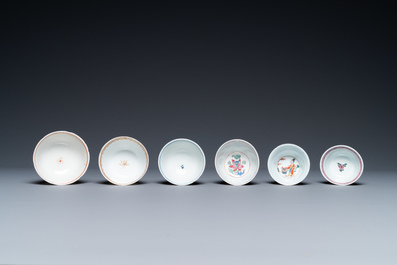 A varied collection of Chinese famille rose and grisaille cups and saucers and a 'rooster' bowl, Yongzheng/Qianlong