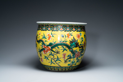 A Chinese yellow-ground famille verte 'dragons' fish bowl on gilded wooden stand, 19th C.