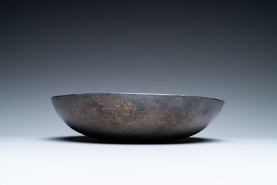 A Persian silver bowl with raised center, 8/12th C.