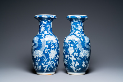 A pair of Chinese blue and white 'dragon and peony' vases, 19th C.