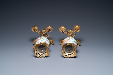 A pair of Chinese gilt brass candelabra-mounted Canton famille rose vases, 19th C.