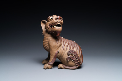 A Chinese Yixing stoneware dog on wooden stand, 19th C