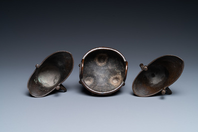 Two Chinese small bronze 'jue' ewers and a tripod censer, probably Yuan