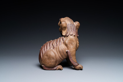 A Chinese Yixing stoneware dog on wooden stand, 19th C