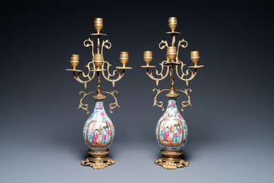 A pair of Chinese gilt brass candelabra-mounted Canton famille rose vases, 19th C.
