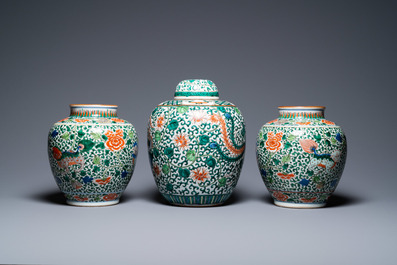 A pair of Chinese 'Buddhist lions' wucai vases and a covered 'phoenix' jar, 19th C.