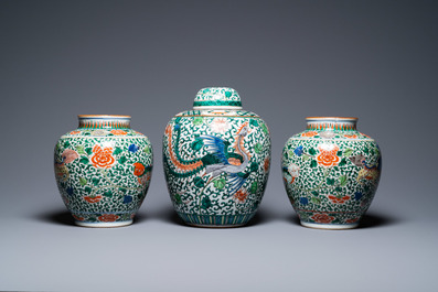 A pair of Chinese 'Buddhist lions' wucai vases and a covered 'phoenix' jar, 19th C.