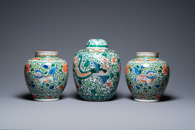 A pair of Chinese 'Buddhist lions' wucai vases and a covered 'phoenix' jar, 19th C.