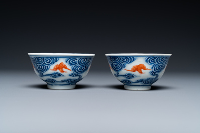 A pair of Chinese blue, white and iron-red cups and a yellow-ground 'dragon' dish, Guangxu mark and of the period