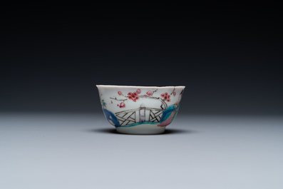 A Chinese famille rose cup and saucer with a couple on a terrace, Qianlong