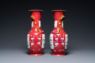 A pair of Chinese famille rose ruby-ground vases, 19th C.