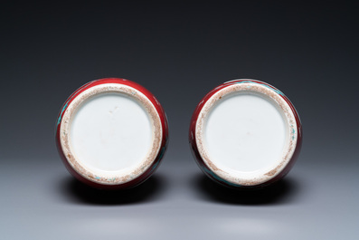 A pair of Chinese famille rose ruby-ground vases, 19th C.