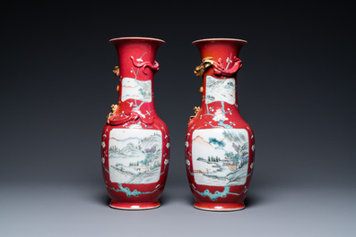 A pair of Chinese famille rose ruby-ground vases, 19th C.