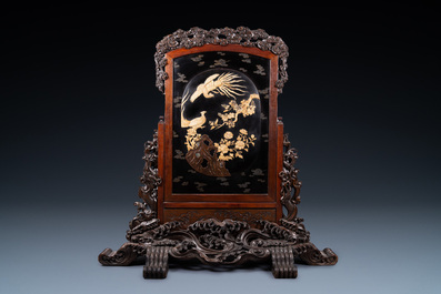 A large Japanese wooden screen with a central gilt-lacquered and ivory-inlaid panel, Meiji