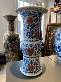 A Chinese blue, white and copper-red 'gu' vase with lotus scrolls, Kangxi