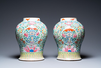 A pair of Chinese famille rose vases with wooden covers and stands, 19th C.