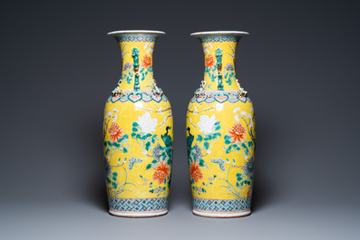 A pair of Chinese yellow-ground famille rose vases, 19th C.