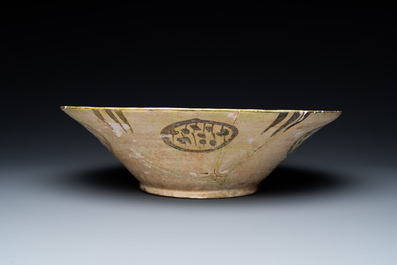 A large Nishapur 'imitation lustre' pottery bowl with a bird, Persia, 10th C.