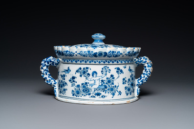 A Dutch Delft blue and white tureen and cover with putti, 17/18th C.