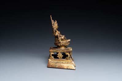 A Sino-Tibetan gilt bronze figure of Ushnishavijaya on a lotus throne with an inscription on the back, 18th C.