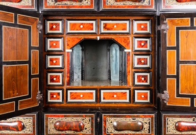 A tortoise veneer, gilt copper, ebony and ebonised wooden mirrored interior cabinet on stand, Antwerp, 17th C.