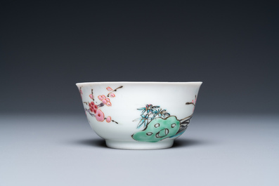 A Chinese famille rose cup and saucer with a couple on a terrace, Qianlong