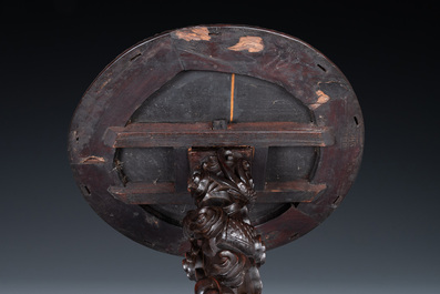 A Chinese wooden table with a Canton famille rose plaque, 19th C.