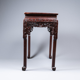 A Chinese rectangular carved wooden table with marble top, 19th C.