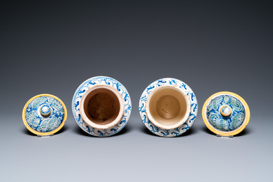 A pair of polychrome Italian maiolica covered albarelli with 'a trofei' design, Casteldurante, dated 1576