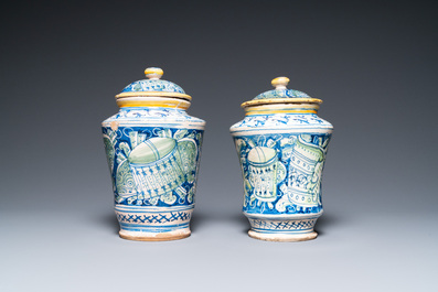 A pair of polychrome Italian maiolica covered albarelli with 'a trofei' design, Casteldurante, dated 1576