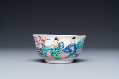 A Chinese famille rose cup and saucer with a couple on a terrace, Qianlong