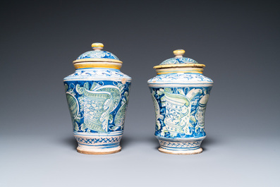 A pair of polychrome Italian maiolica covered albarelli with 'a trofei' design, Casteldurante, dated 1576