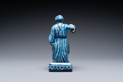 A Dutch Delft blue and white figure of a seated lady, 18th C.