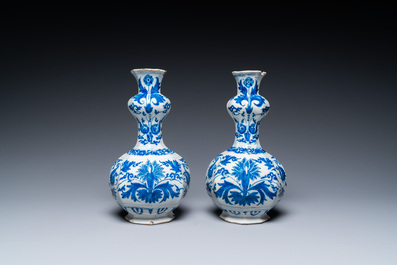 A pair of Dutch Delft blue and white 'garlic head' vases with lotus design, late 17th C.