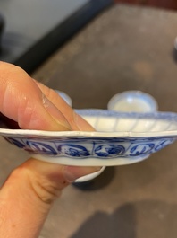 Three Chinese blue and white lotus-shaped 'acupuncture' cups and saucers, Kangxi