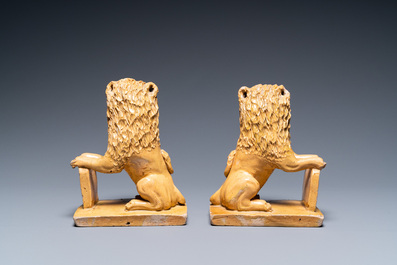 A pair of Flemish or North-French pottery lions, signed and dated 1865