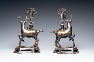 A pair of Chinese bronze deer-shaped candlesticks, Kangxi/Qianlong