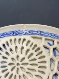 A pair of Chinese blue and white reticulated double-walled cups and saucers, Kangxi