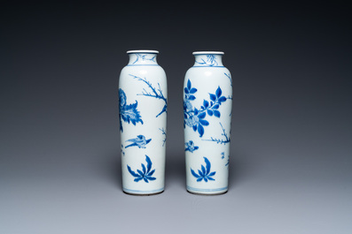 A pair of Chinese blue and white rouleau vases with birds among blossoming branches, Transitional period