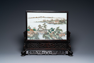 A Chinese rectangular famille rose 'landscape' plaque mounted in a wooden table screen, 19/20th C.